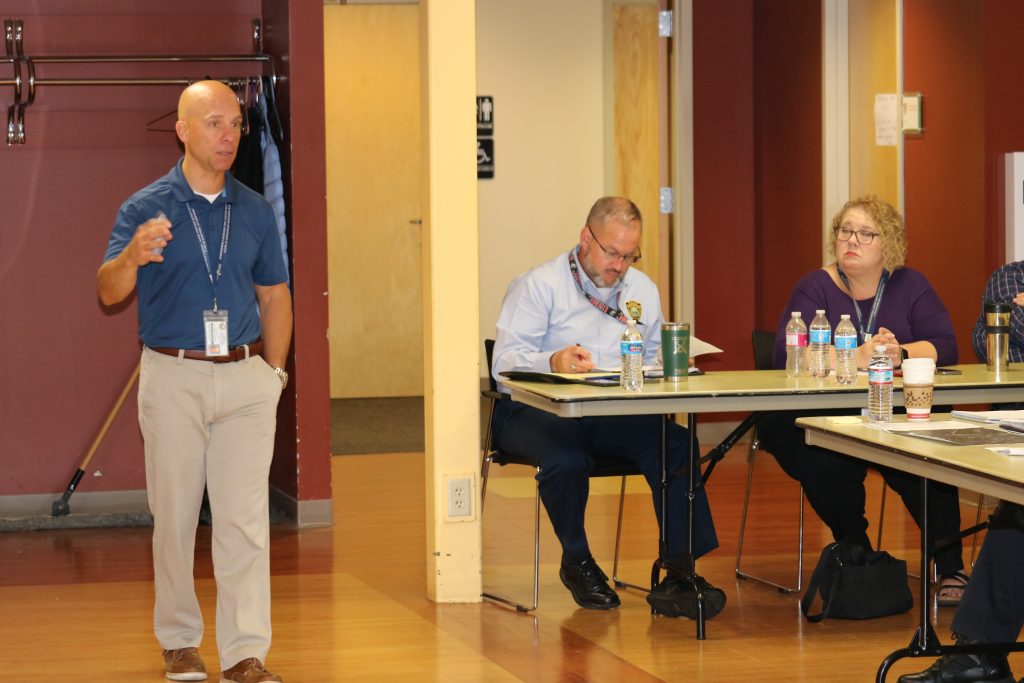 A photo of HSEM Exercise and Training Office Steven Cooper facilitating a tabletop exercise in Stratham as School Readiness Liaison Kevin Partington and Training and Exercise Supervisor Deb Yeager look on.
