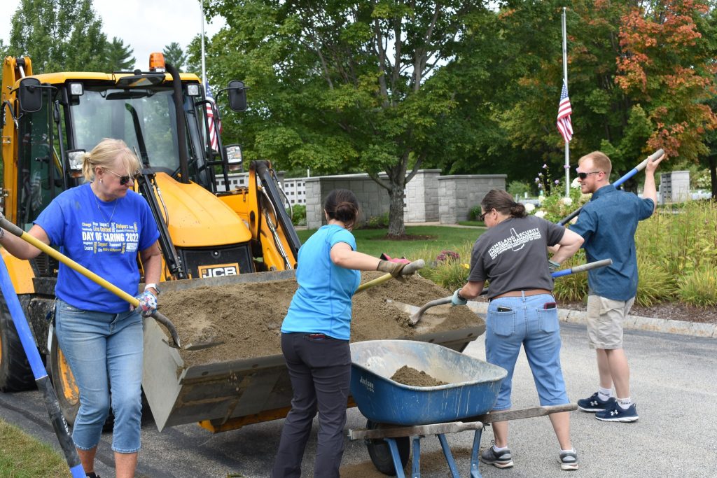 A photo of the HSEM Community Outreach Office shoveling dirt for the Granite United Way Day of Caring.