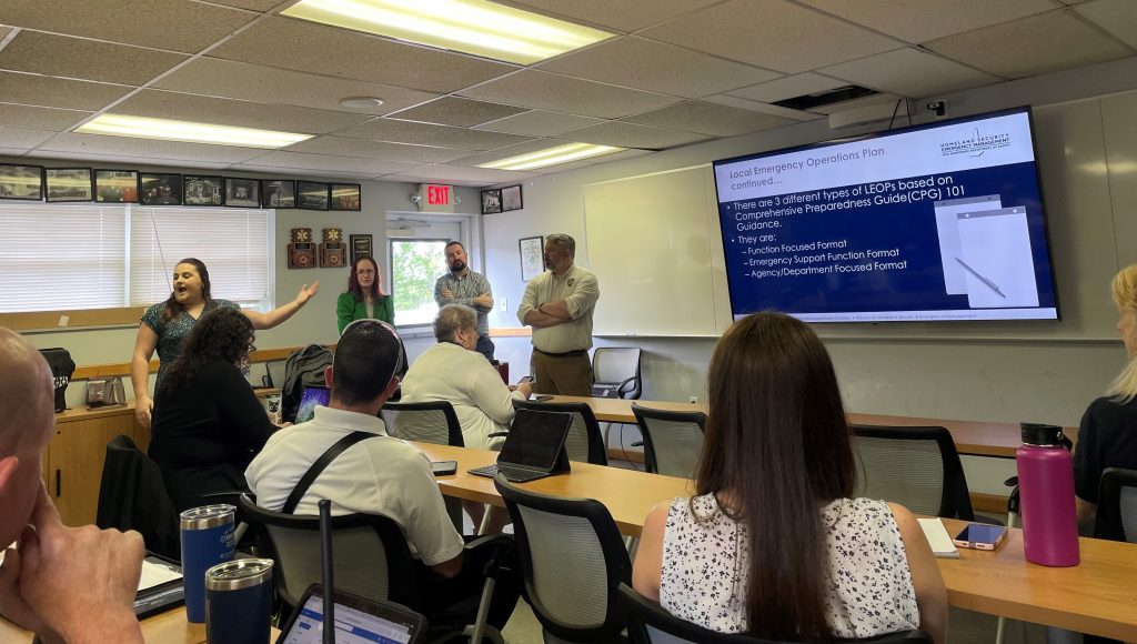 Several members of H S E M conduct the new E M D 101 training to a group of people sitting in a classroom