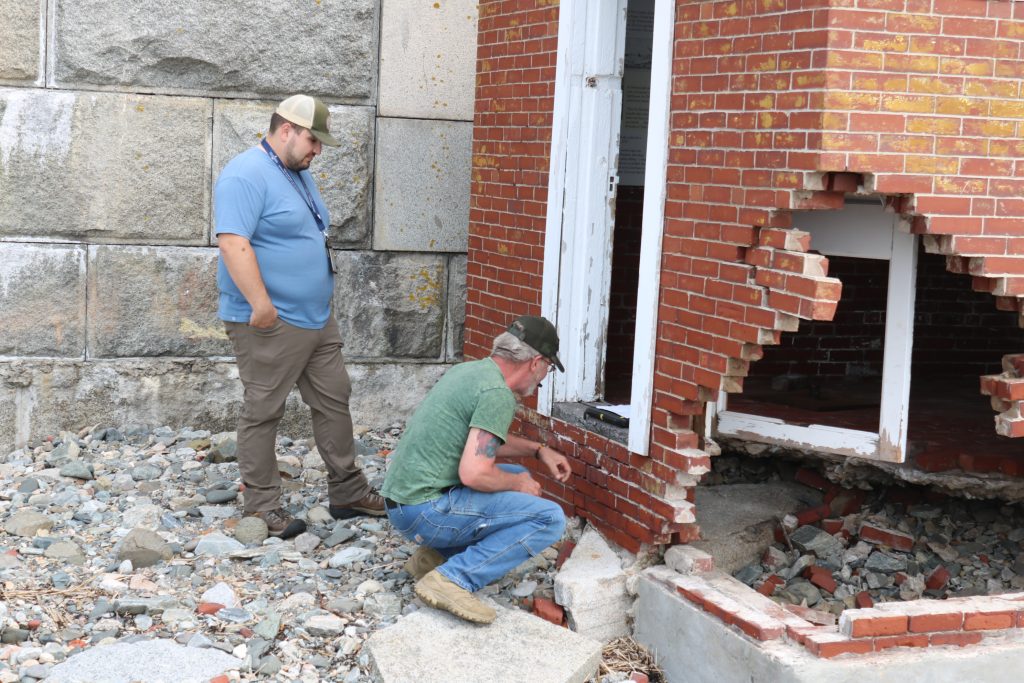 Austin Brown of H S E M assesses the damage of the New Castle lighthouse.